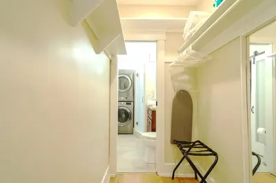 a hallway with a washer and dryer in a house at The Heron On Ivy in San Diego