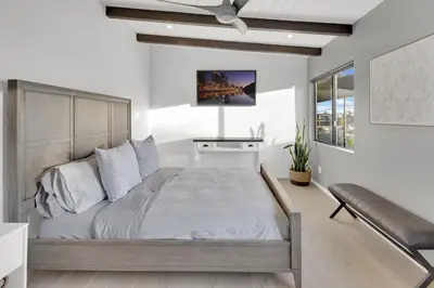 a bedroom with a large bed and a couch at New! Luxury 5BR, W/Arcade, Sauna, Views, Fire Pit! in San Diego