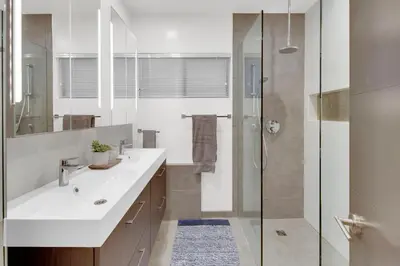 a bathroom with a white sink and a shower at New! Luxury 5BR, W/Arcade, Sauna, Views, Fire Pit! in San Diego