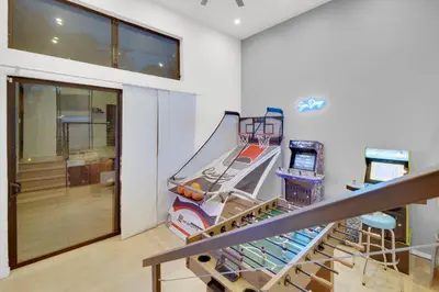 a room with an empty gym with a slide at New! Luxury 5BR, W/Arcade, Sauna, Views, Fire Pit! in San Diego