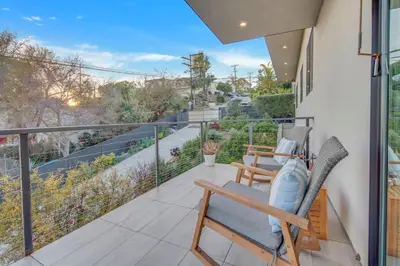 a balcony with chairs and a view of a street at New! Luxury 5BR, W/Arcade, Sauna, Views, Fire Pit! in San Diego
