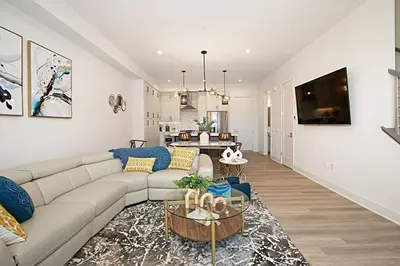 a living room with a couch and a table at Luxury NEW Residence with Private Rooftop, Downtown in minutes in San Diego