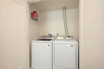 a washer and dryer in a small room at Luxury NEW Residence with Private Rooftop, Downtown in minutes in San Diego
