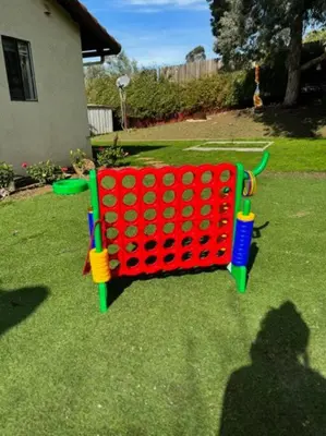 a red and green object sitting on the grass at San Diego Trail Guest Ranch in Poway