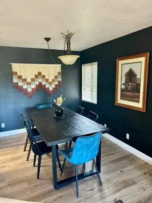 a dining room with a black table and chairs at San Diego Trail Guest Ranch in Poway