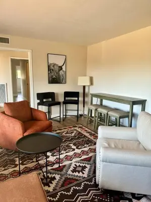 a living room with couches and a table and chairs at San Diego Trail Guest Ranch in Poway
