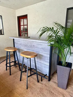 a bar with two stools and a plant at San Diego Trail Guest Ranch in Poway