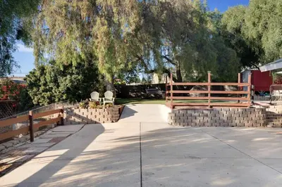a walkway with a fence and a tree at Wonderland Retreat - Near Downtown, Free Parking in San Diego