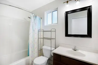 a bathroom with a toilet and a sink and a mirror at Wonderland Retreat - Near Downtown, Free Parking in San Diego