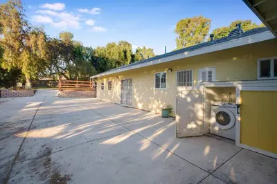 a house with a washing machine in a driveway at Wonderland Retreat - Near Downtown, Free Parking in San Diego