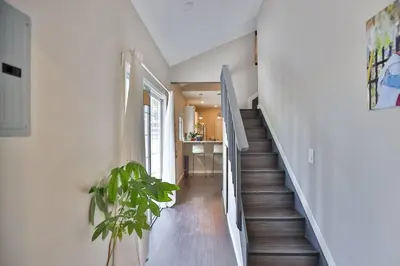 a hallway with a staircase with a potted plant at Wonderland Retreat - Near Downtown, Free Parking in San Diego