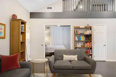 a living room with a couch and a bed at Wonderland Retreat - Near Downtown, Free Parking in San Diego