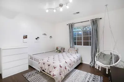 a bedroom with a swinging bed and a window at Wonderland Retreat - Near Downtown, Free Parking in San Diego