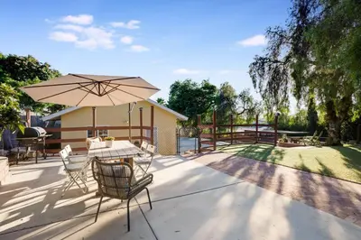 a patio with a table and an umbrella at Wonderland Retreat - Near Downtown, Free Parking in San Diego