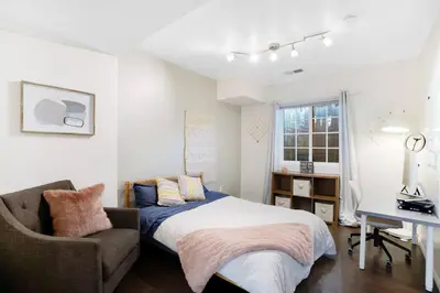 a bedroom with a bed and a chair and a desk at Wonderland Retreat - Near Downtown, Free Parking in San Diego