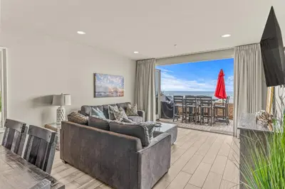 a living room with a couch and a table at Oceanside Escape 700S-102 in Oceanside