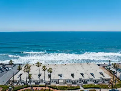an aerial view of a building next to the ocean at Oceanside Escape 700S-102 in Oceanside