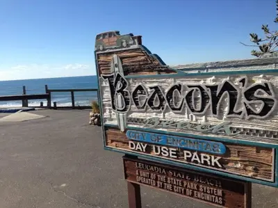 a sign for a day use park at the beach at * - The Leucadia Beach Grotto - * An Encinitas Gem in Encinitas