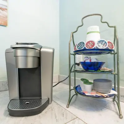 a kitchen with a coffee maker and a shelf with dishes at * - The Leucadia Beach Grotto - * An Encinitas Gem in Encinitas