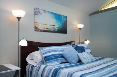a bedroom with a bed with two lamps on it at * - The Leucadia Beach Grotto - * An Encinitas Gem in Encinitas