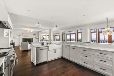 a large kitchen with white cabinets and a large island at La Jolla Cove-Oceanfront 5600SF 3BR+Loft 5BA House best Villiage location walk everywhere in San Diego