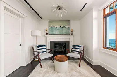 a living room with two chairs and a fireplace at La Jolla Cove-Oceanfront 5600SF 3BR+Loft 5BA House best Villiage location walk everywhere in San Diego