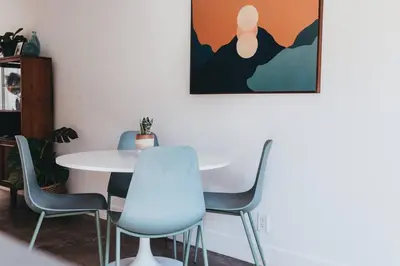 a dining room with a white table and chairs at Casa de Vaqueros! Family&Pet Friendly! 3mi to the Beach! in San Juan Capistrano