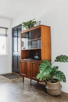a wooden cabinet with two potted plants in a room at Casa de Vaqueros! Family&Pet Friendly! 3mi to the Beach! in San Juan Capistrano