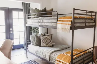 a bedroom with two bunk beds with pillows at Casa de Vaqueros! Family&Pet Friendly! 3mi to the Beach! in San Juan Capistrano