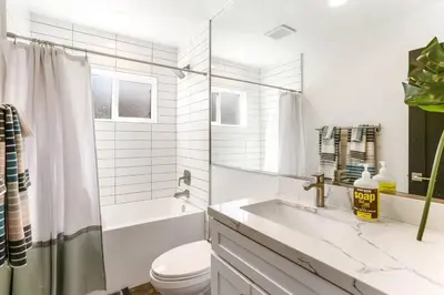 a white bathroom with a sink and a toilet at Casa de Vaqueros! Family&Pet Friendly! 3mi to the Beach! in San Juan Capistrano