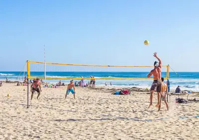 a group of people playing volley ball on a beach at 2 Free Bikes, Pvt Parking, Steps to Beach! South Mission Beach in San Diego