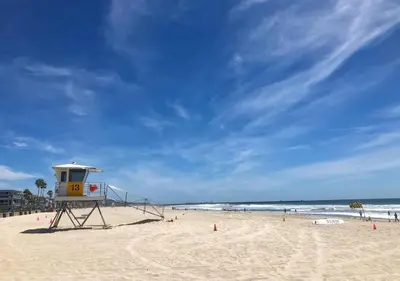a life guard tower on a beach with the ocean at 2 Free Bikes, Pvt Parking, Steps to Beach! South Mission Beach in San Diego