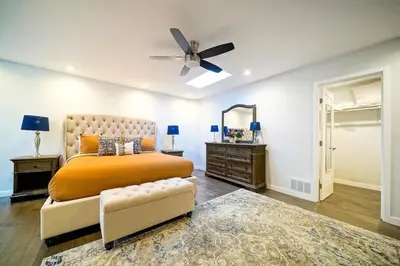 a bedroom with a bed and a ceiling fan at Panoramic Ocean Vistas With Hot Tub and Firepit in San Diego