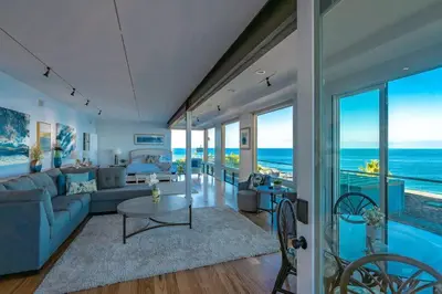 a living room with a couch and a table at Oceanfront Studio in Heart of La Jolla Cove in San Diego