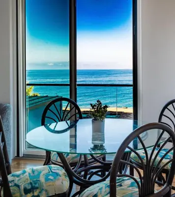 a table and chairs with a view of the ocean at Oceanfront Studio in Heart of La Jolla Cove in San Diego