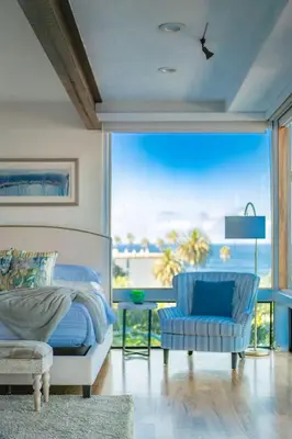 a bedroom with a bed and a view of the ocean at Oceanfront Studio in Heart of La Jolla Cove in San Diego