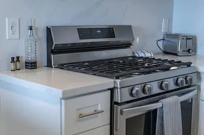 a kitchen with a stove top oven in a kitchen at Oceanfront Studio in Heart of La Jolla Cove in San Diego