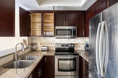 a kitchen with a stainless steel refrigerator and a sink at Blueground Mission Valley w gym pool SAN-43 in San Diego