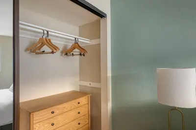 a bedroom with a closet with hangers and a dresser at Blueground Mission Valley w gym pool SAN-43 in San Diego