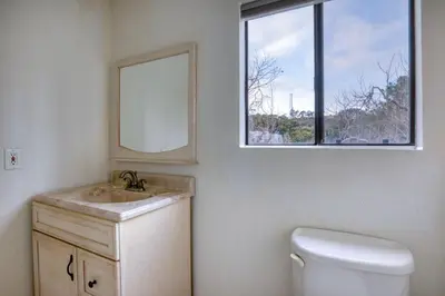 a bathroom with a sink and a mirror and a toilet at Blueground Mission Valley w gym pool SAN-43 in San Diego