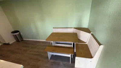 a table and bench in a room with green walls at Walking Distance to Little Italy in San Diego