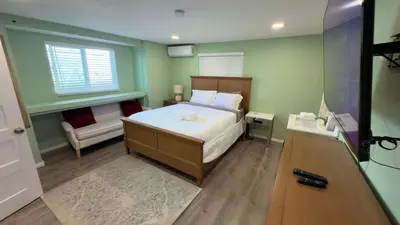 a small bedroom with a bed and a window at Walking Distance to Little Italy in San Diego