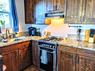 a kitchen with wooden cabinets and a stove top oven at #2 - The Eagle's Perch in Pauma Valley