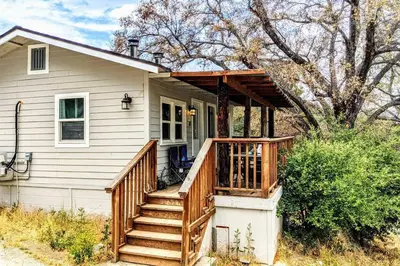 a house with a porch with a wooden deck at #3 Howling Wolf's Lair - Cabin W/Fireplace & Views in Santa Ysabel