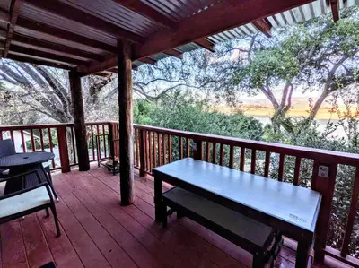 a bench on a deck with a view of a river at #3 Howling Wolf's Lair - Cabin W/Fireplace & Views in Santa Ysabel
