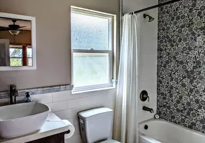 a bathroom with a sink and a toilet and a window at #3 Howling Wolf's Lair - Cabin W/Fireplace & Views in Santa Ysabel