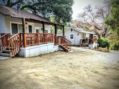 a house with a large deck on a house at #7 Josie's Mountain Top Hideout-Cabin in the Woods in Santa Ysabel