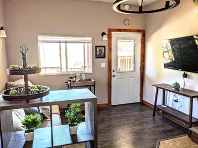 a living room with a table and a tv at #7 Josie's Mountain Top Hideout-Cabin in the Woods in Santa Ysabel