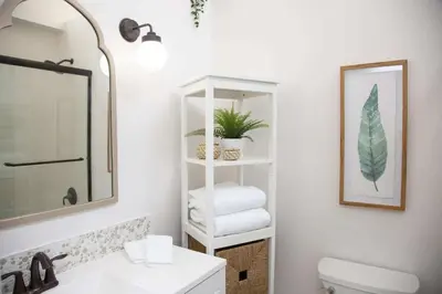 a bathroom with a toilet and a sink and a mirror at Boho Solana Stunner in Solana Beach