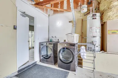 a laundry room with two washing machines in it at Sunny Oceanside Home with Patio, 5 Mi to Downtown! in Oceanside